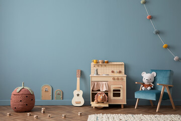 Warm composition of kid room interior with blue wall, kitchen for kids, stylish armchair, colorful...