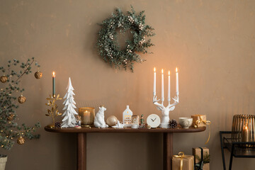 Elegant composition of christmas living room interior with wooden console, stylish wreath, deer...