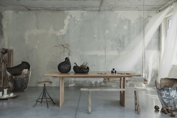 Composition of japandi dining room space with wooden table, gray concrete raw wall, white curtain,...