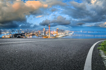 Asphalt road and commercial buildings skyline background in Macau