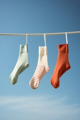 Hanging clothes cotton laundry socks pair background blue clothesline dry clothespin rope line