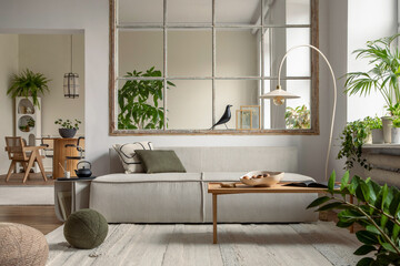 Interior design of open space interior with modular sofa, big window, stylish lamp, wooden coffee table, round table, rattan chair, pillows, plants and personal accessories. Home decor. Template.
