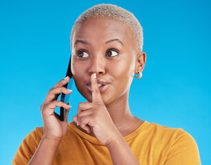 Phone call, secret or finger on lips of black woman in studio for mystery, gossip or conversation. Privacy, news or whisper with girl or shush gesture on blue background for rumor, drama or silence