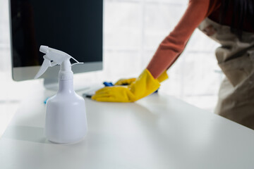 Cleaning staff wiping down office equipment, Wipe the keyboard clean with a towel and sanitizer, Wear rubber gloves when working with cleaning chemicals, cleaning idea.