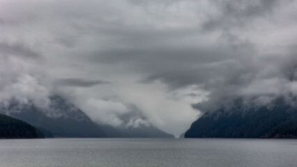 Dramatic clouds and fog over Alouette Lake and Golden Ears Provincial Park. Maple Ridge, British Columbia - obrazy, fototapety, plakaty