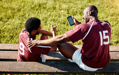 Obraz premium Rugby, teamwork and phone with sports man friends sitting on the bench during a game outdoor. Sport, fitness or social media with a male athlete and friend taking a break from training to rest