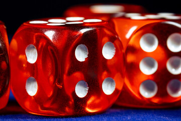 Red dice close-up on a blue casino table - obrazy, fototapety, plakaty