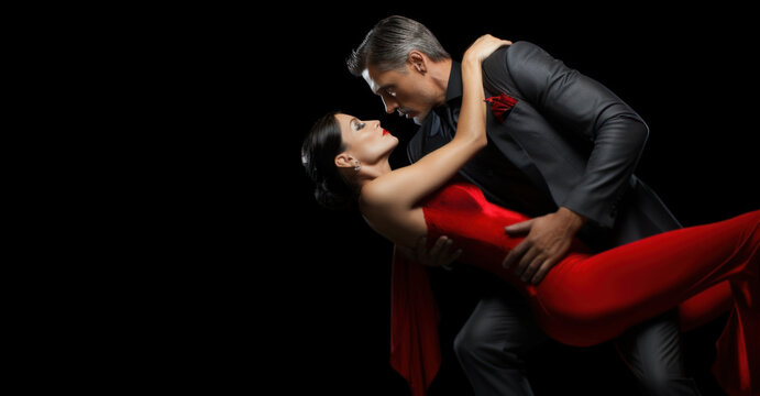 beautiful couple man and woman in red dress dancing tango