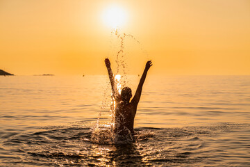 Swimming in the setting sun, in to the sun, Corsica, France