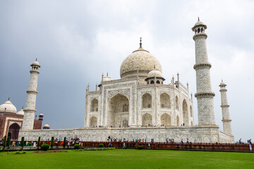 View of the imposing Taj Mahal in Agra, India, with its wonderful architecture and gardens on a cloudy day
