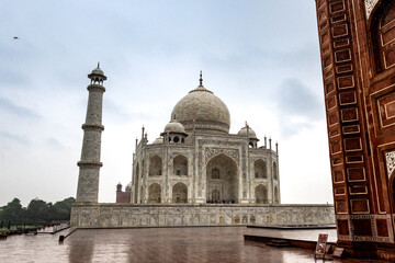 View of the imposing Taj Mahal in Agra, India, with its wonderful architecture on a cloudy day from the side
