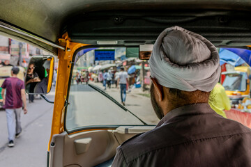 riding the streets of India by rickshaw, among the chaos and people in Rajastan