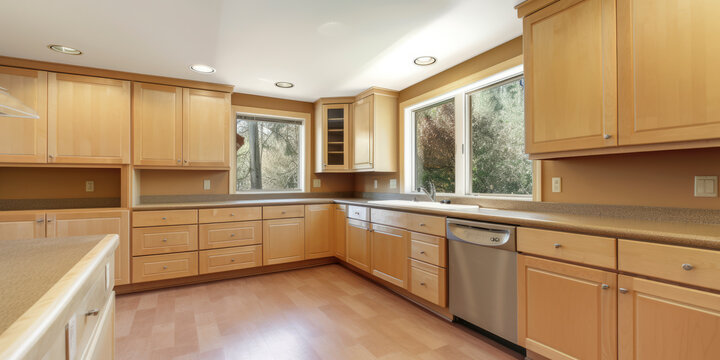 Empty kitchen in wood look with large windows