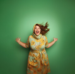 excited beautiful happy woman plus size model screams on green background