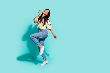 Fototapeta na wymiar Full size photo of nice woman with long hairstyle dressed flower print blouse enjoy music dancing isolated on turquoise color background