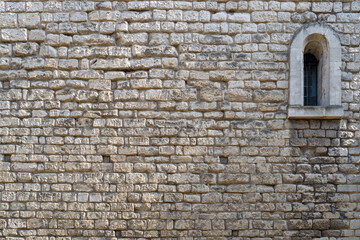 Fototapeta na wymiar Old stone wall background with arched window. Textured backdrop will space for text.