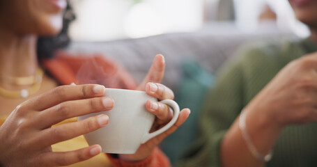 Lgbtq couple, coffee and women on sofa in home for bonding, connection and relax together. Love, lesbian date and hands of people drinking tea in living room for chatting, social visit and talking - obrazy, fototapety, plakaty