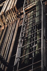 Obraz premium Industrial construction featuring multiple silver pipes and electric cables