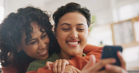 Phone, hug and a gay couple laughing together in their home while browsing a social media app. LGBT, love and comedy with happy lesbian women looking at a meme on a mobile for fun, romance or bonding - obrazy, fototapety, plakaty