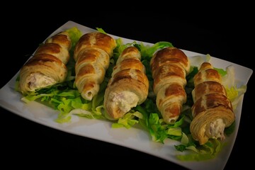 Closeup of freshly-baked croissants with fillings on a plate