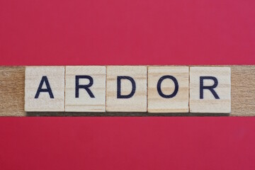 text the word ardor from gray wooden small letters with black font on an red table