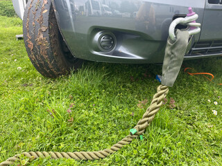 A tow rope has been attached to the front towing eye of a motorhome using a heavy duty shackle.Tyre...