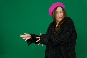 woman on a green background chromakey in a black striped mens shirt different emotions facial expression close-up advertising space for text clean. kind eyes