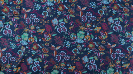 colorful Floral summer fabric pattern. Blue and pink flowers on a black background.