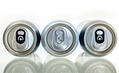 Three aluminum can on a plane surface