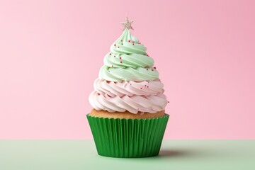 Christmas green cupcake or muffin with pink whipped cream, sprinkles and gold star on pink background. Xmas homemade dessert. Minimal style. - obrazy, fototapety, plakaty