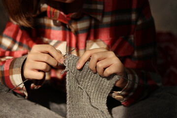 hands of a person with knitting