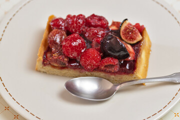 part de tarte aux fruits rouges dans une assiette, en gros plan