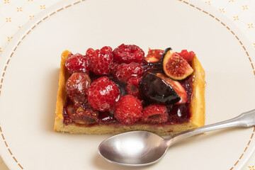 part de tarte aux fruits rouges dans une assiette, en gros plan