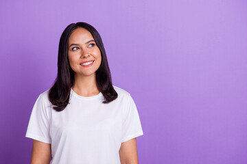 Fototapeta premium Portrait of charming latin girl wearing casual white t shirt looks empty space ponder planning idea isolated on purple color background