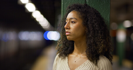 Young black woman serious sad face at subway platform
