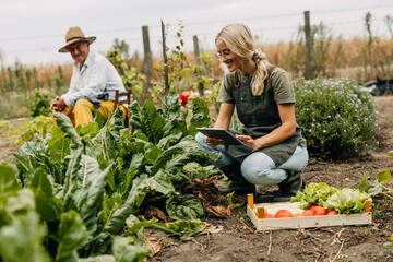 Pretty young woman is working in her grandfathers garden.
