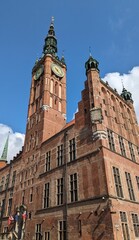 Majestic brick building of the Main Town Hall of Gdansk with a large clock tower