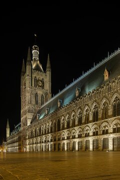 Vertical shot of the In Flanders Fields Museum at night in Ypres, Belgium