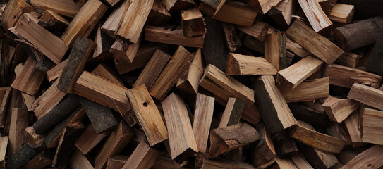 stacked dry firewood as a background - obrazy, fototapety, plakaty