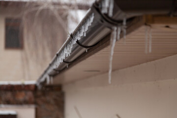 Icicles hang on roof....