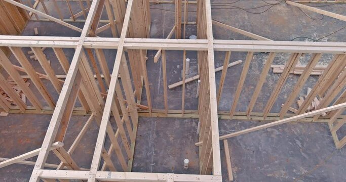 Work in progress view of unfinished house construction with wooden framing beams
