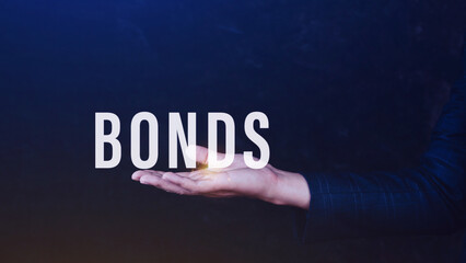 Businessman holding bonds virtual screen. Bond Finance Banking Technology concept, Trade Market Network, bond security that indicates the investor has provided loan the issuer, Equivalent loan