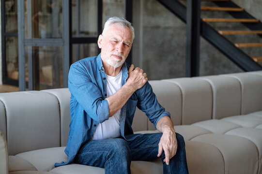 Senior man suffering from pain in shoulder - Powered by Adobe