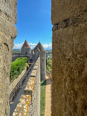 looking down the ramparts through an arrow slit in Carcassonne France