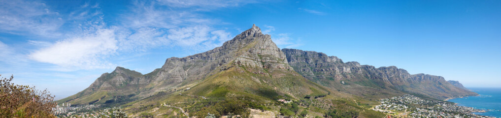 Fototapeta premium Landscape of a mountain against a blue sky with copyspace. A popular travel destination for tourists and hikers to explore. View of Table Mountain and the twelve apostles in Cape Town, Western Cape