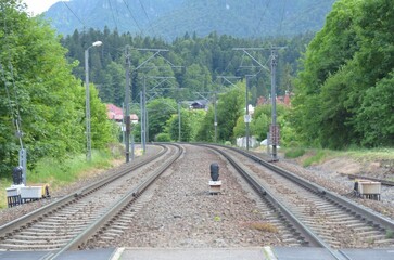 Railroad station featuring a view of the tracks extending in the foreground