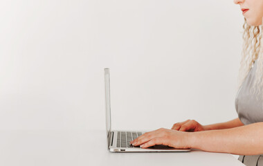 Woman working with laptop, side view, white background, minimalism