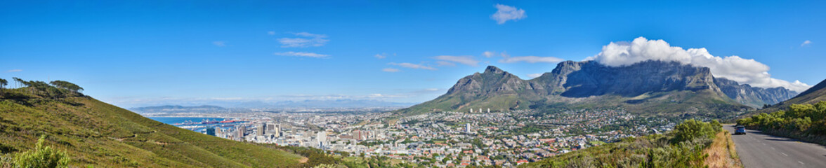 Fototapeta na wymiar Wide angle of Cape Town and mountain landscape on a sunny day. Beautiful view of a city against a blue horizon. A popular travel destination for tourists and hikers, on Table Mountain, South Africa