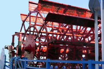 Large industrial construction site with a large red ship blade wheel