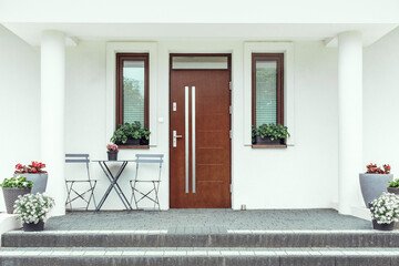 Designer entrance door to a country house. Modern design. luxurious exterior. Facade of a modern building with modern doors. - obrazy, fototapety, plakaty